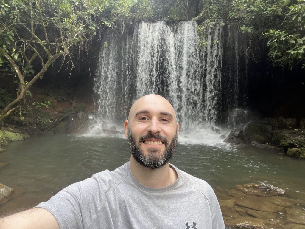 Zac in front of a waterfall